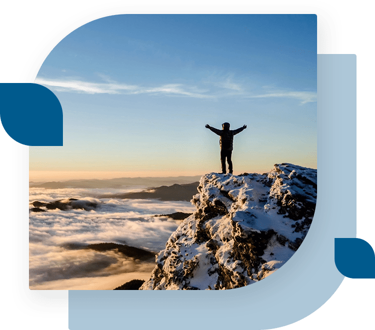 A person standing on top of a rock.