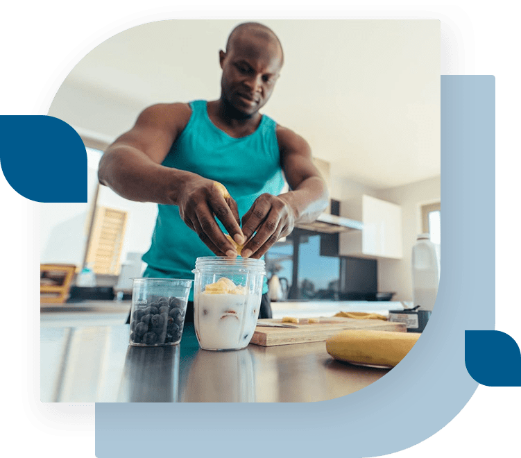 A man is preparing food in the kitchen.