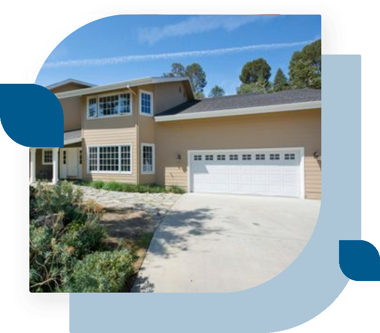 A house with a driveway and garage in front of it.