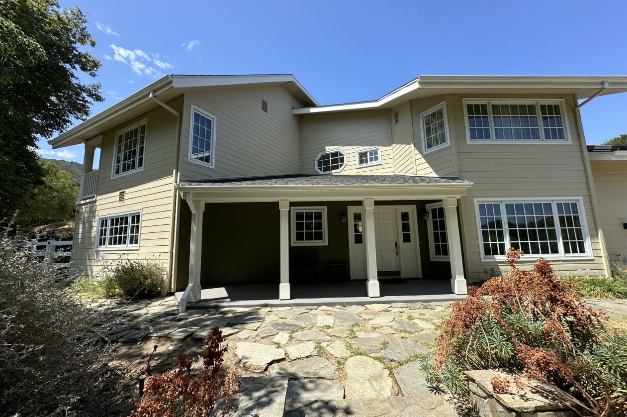 A large house with many windows and doors.