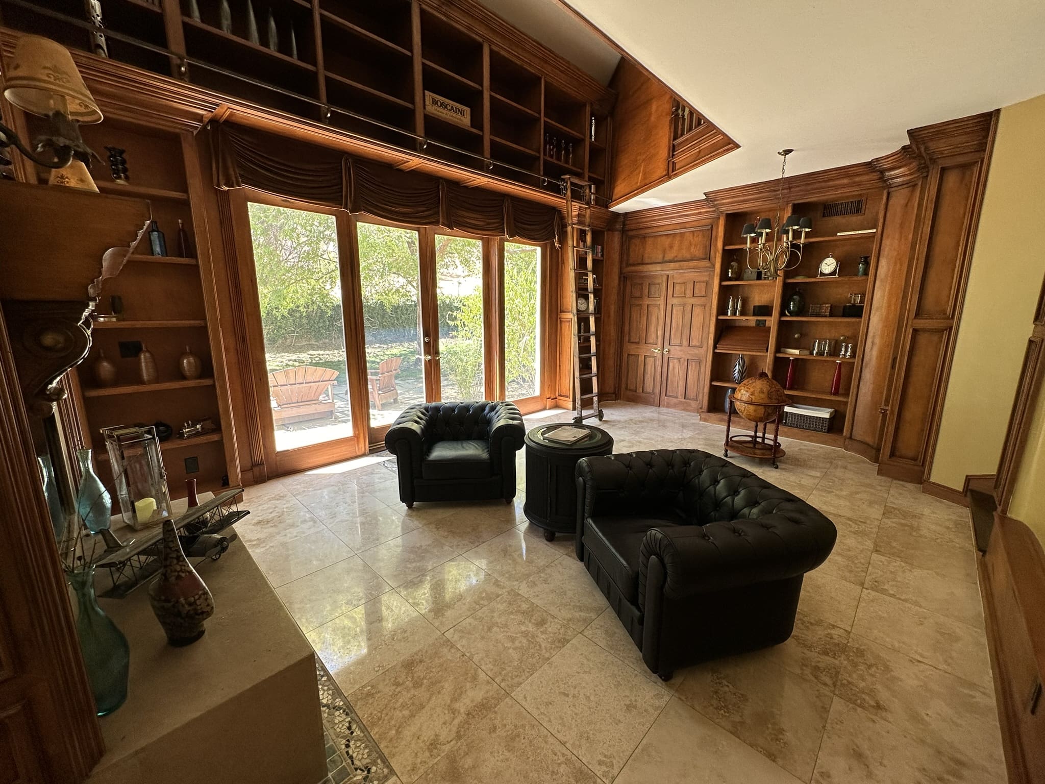 A living room with two chairs and a couch