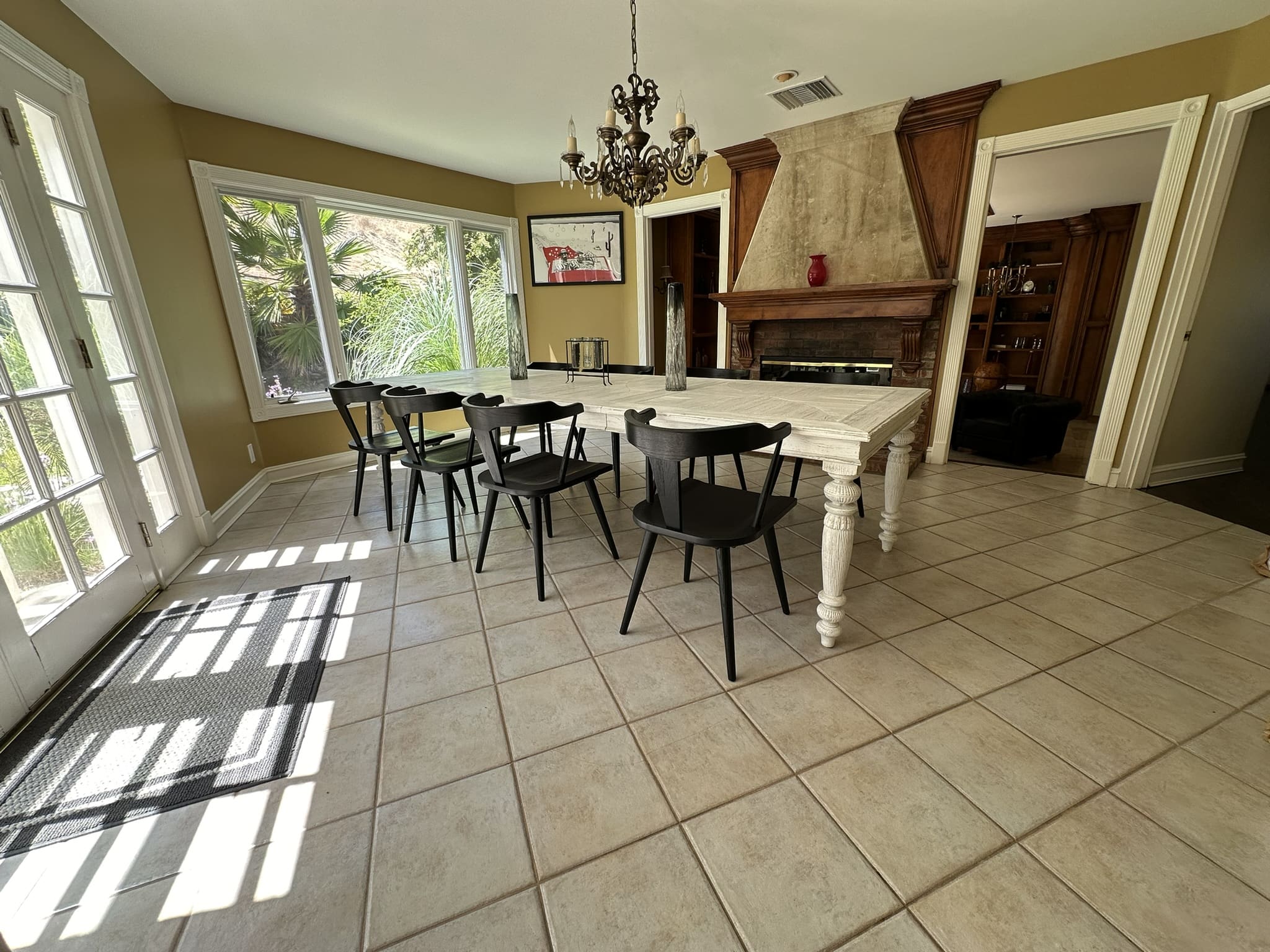 A large dining room table with chairs around it.