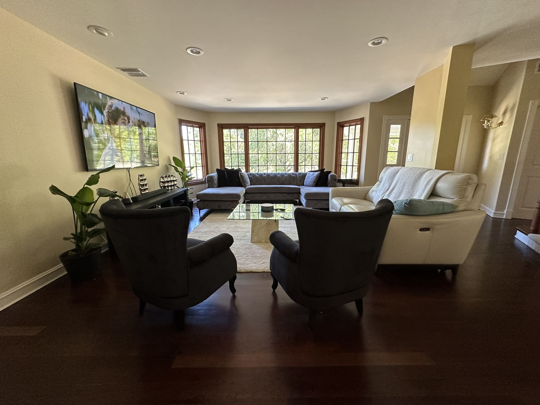 A living room with many chairs and couches